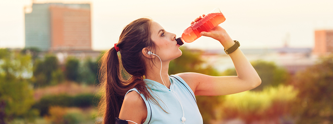 Woman drinking a drink during exercise